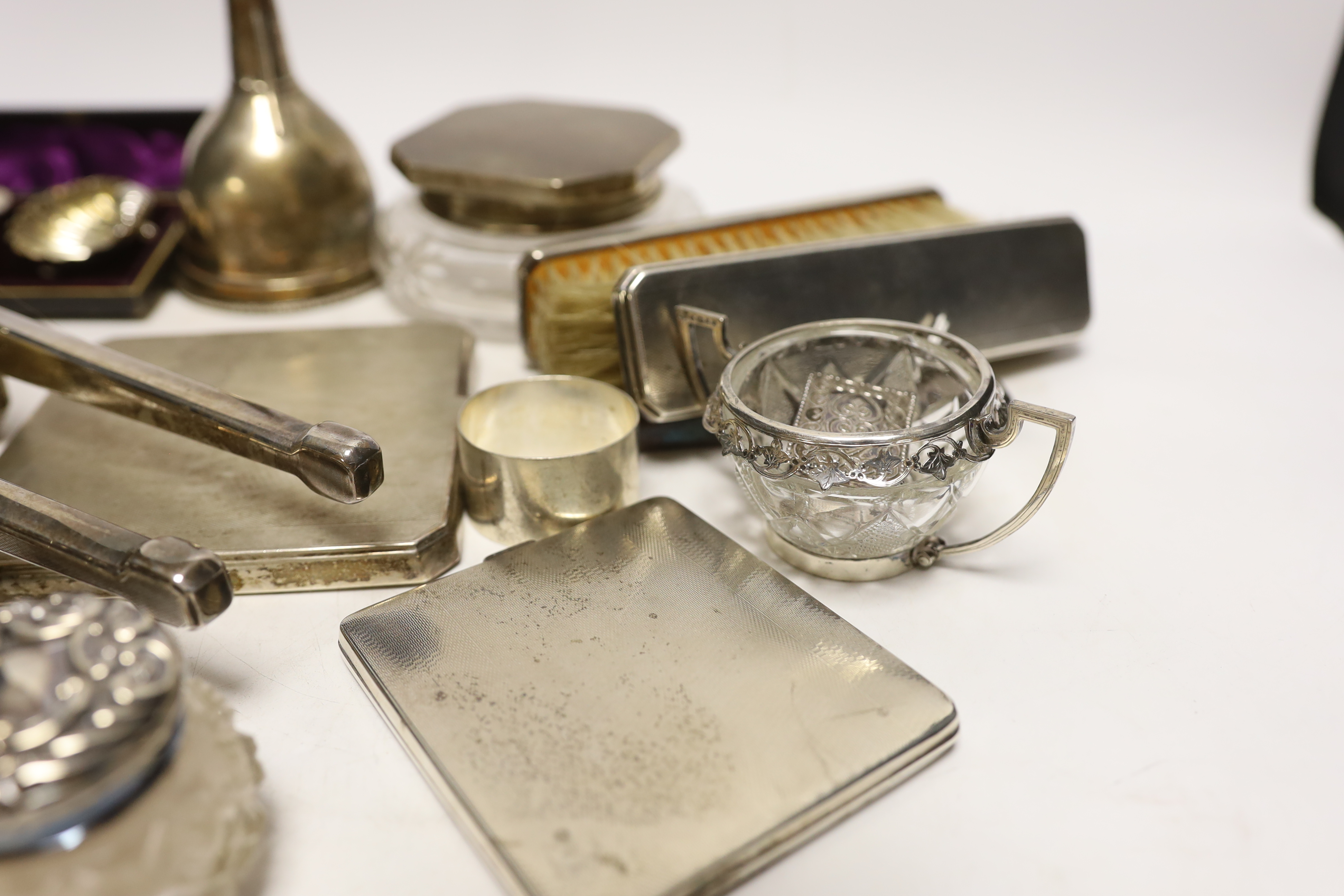 A group of assorted small silver, including a powder jar, trinket box, cigarette case, mirror and brush set etc. and a plated wine funnel.